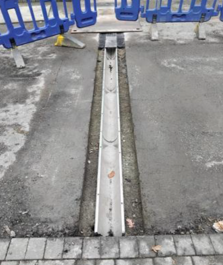 ACO rainwater drain repair replacement channel with barriers in place